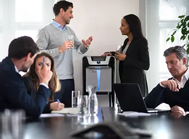 People in a meeting around a water cooler