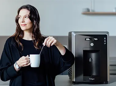 Person making hot tea using the water cooler