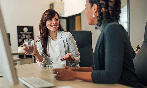 Office workers discussing water cooler options