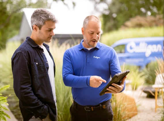 A Culligan team member installing a water dispenser into an office space