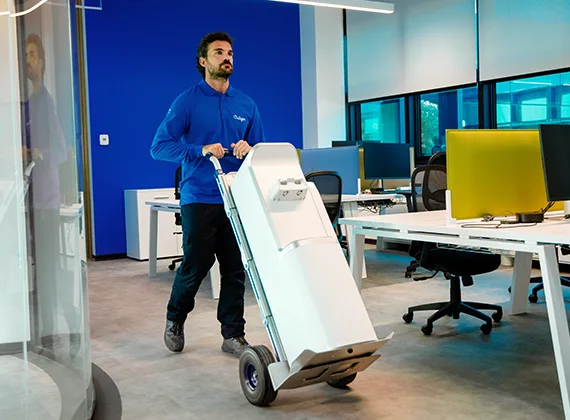 A Culligan team member installing a water dispenser into an office space