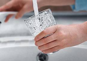 Glass of water being filled from the tap