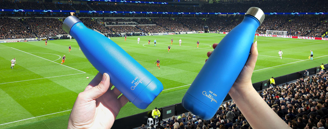 Two bottles with football field as background