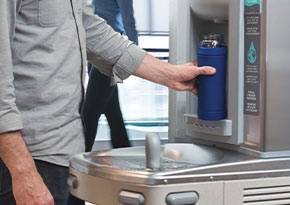 Man filling a bottle from a water dispenser
