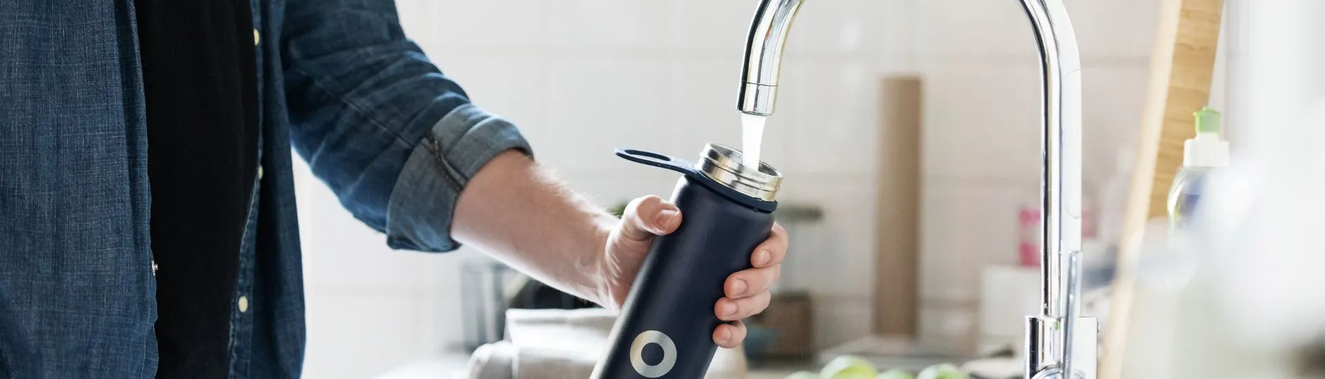 filling up a reusable water bottle