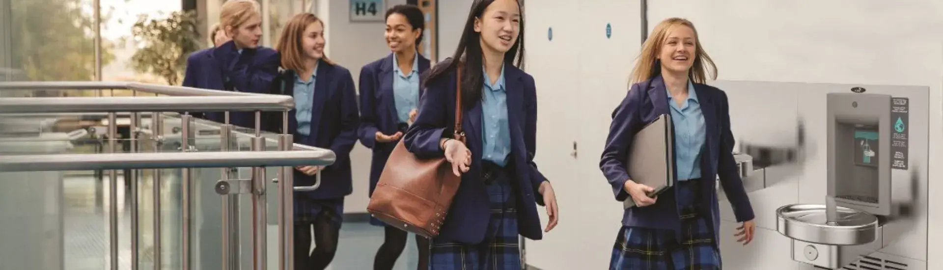 school corridor with students and water fountain