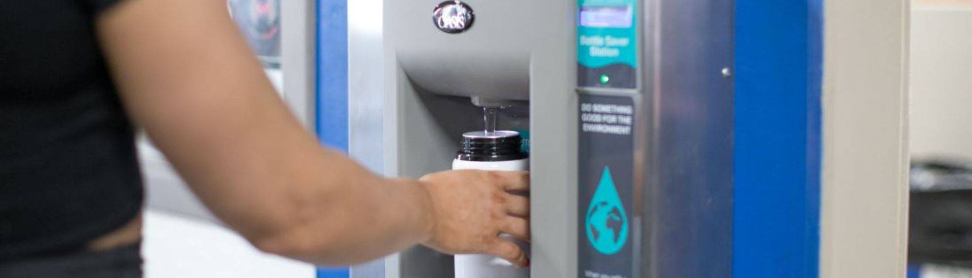 filling up reusable bottle at a water cooler