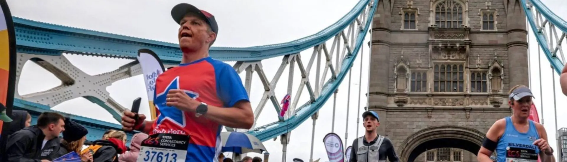 a man running over tower bridge at the london marathon