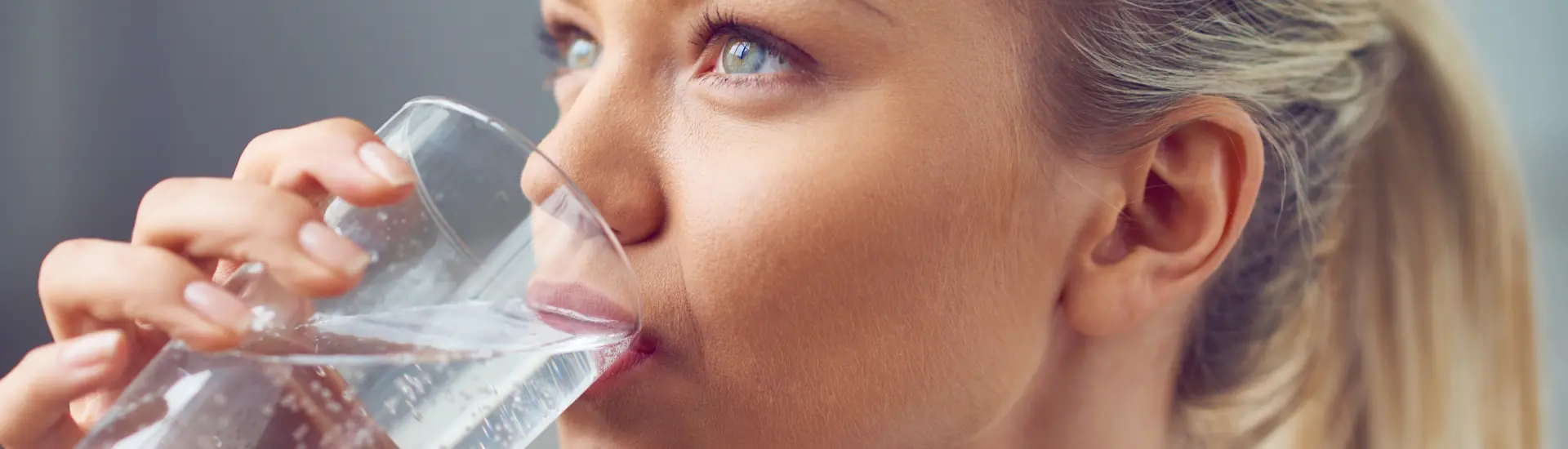 woman drinking a glass of clean water