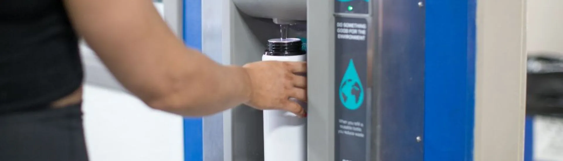 filling up a bottle at a refill station