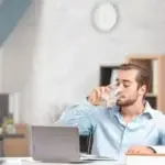 man drinking water at work