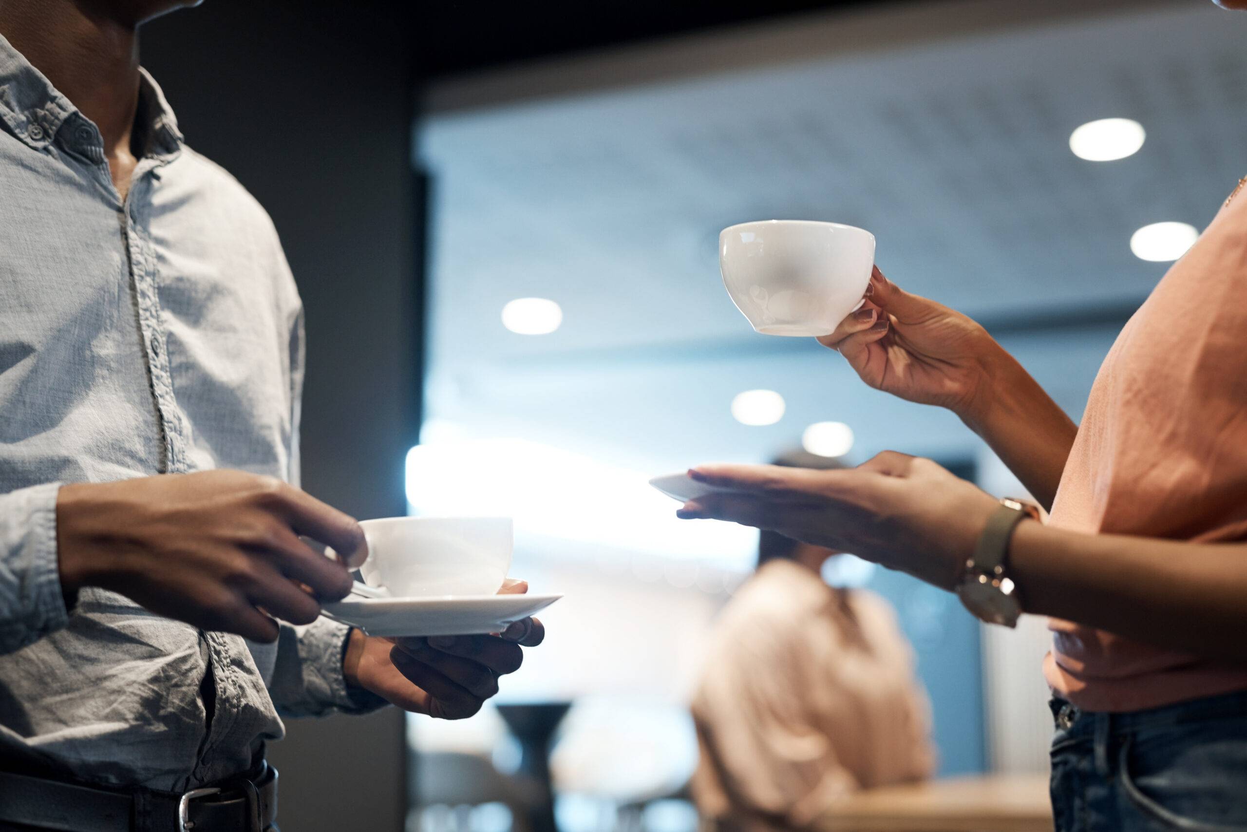 Coffee break, team and closeup with hands at networking event for a discussion with a partnership. Professional, teamwork and tea for conversation with hand at a company with communication.