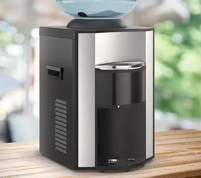 Countertop coffee grinder with silver accents in a bright kitchen.